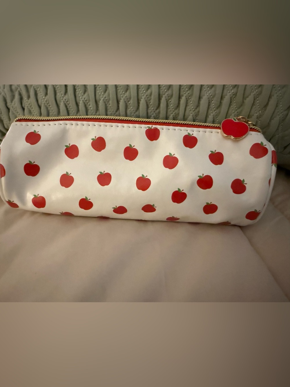 White Apple-Print Cosmetic Pouch with Red Zip Charm. DORM ESSENTIALS
